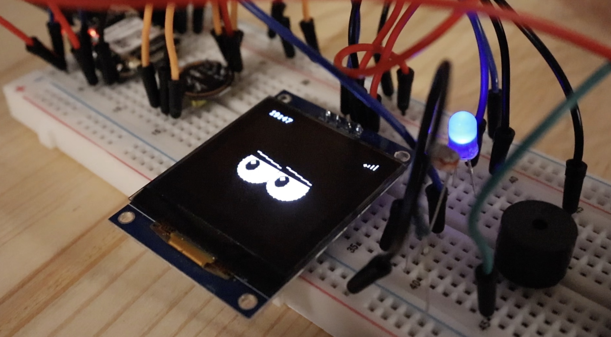 Breadboard prototype with the OLED, microphone, reminder LED, and buzzer